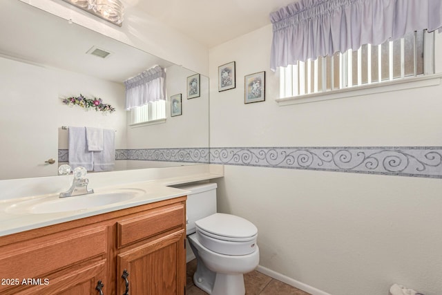 bathroom with vanity, tile patterned floors, and toilet