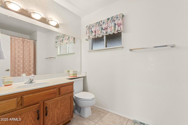 bathroom featuring vanity, tile patterned floors, and toilet