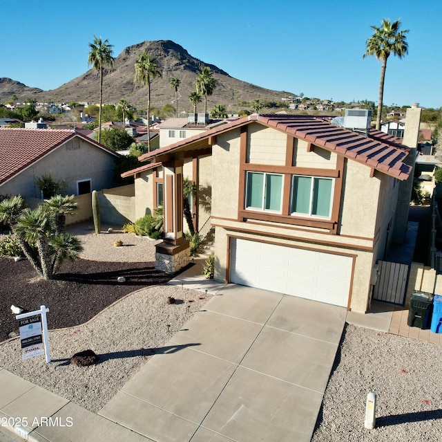 view of front facade with a mountain view and a garage