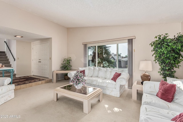 carpeted living room with lofted ceiling and a textured ceiling