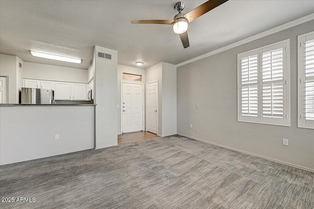20100 N 78th Pl Unit 2019, Scottsdale, AZ 85255 - unfurnished living room featuring a ceiling fan, crown molding, carpet, and a textured ceiling