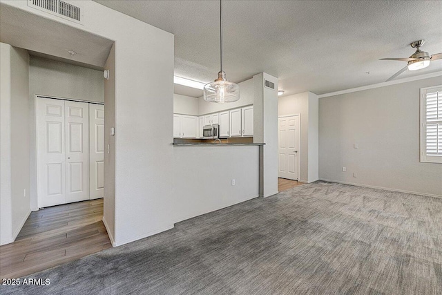 20100 N 78th Pl Unit 2019, Scottsdale, AZ 85255 - unfurnished living room featuring ceiling fan, wood finished floors, and a textured ceiling