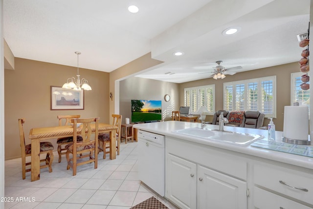 kitchen with ceiling fan with notable chandelier, white dishwasher, sink, pendant lighting, and white cabinets