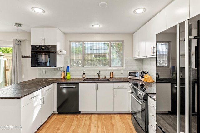 kitchen with white cabinetry and black appliances