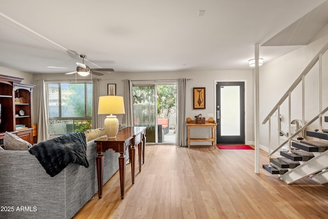 living room featuring a wealth of natural light, light hardwood / wood-style flooring, and ceiling fan