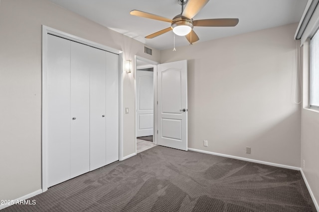 unfurnished bedroom with a closet, ceiling fan, and carpet