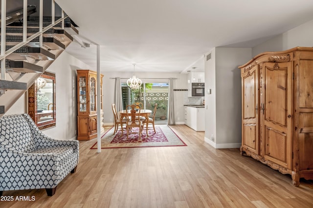 interior space featuring an inviting chandelier and light wood-type flooring