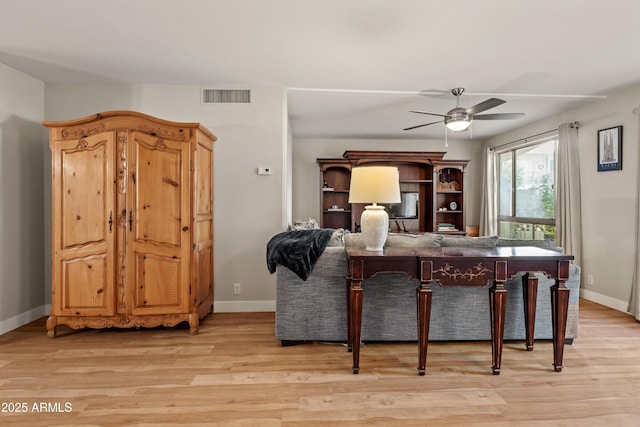 living room with ceiling fan and light hardwood / wood-style floors