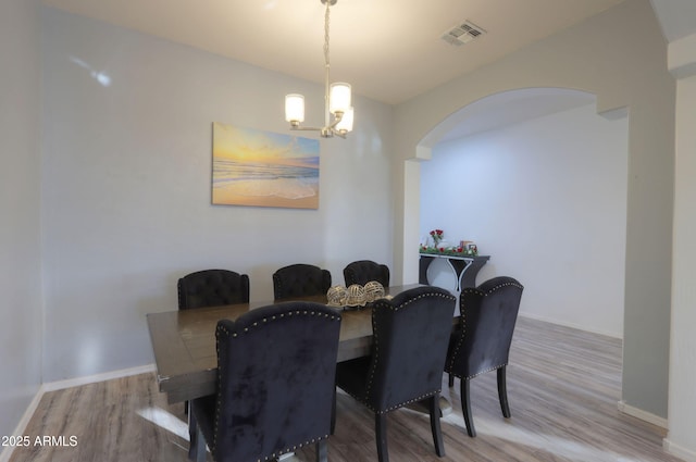 dining space featuring a notable chandelier and light hardwood / wood-style flooring