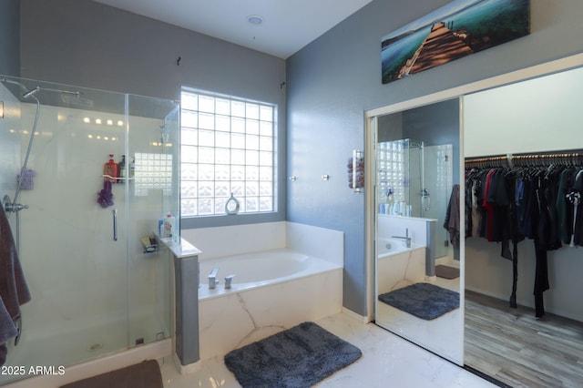 bathroom with shower with separate bathtub