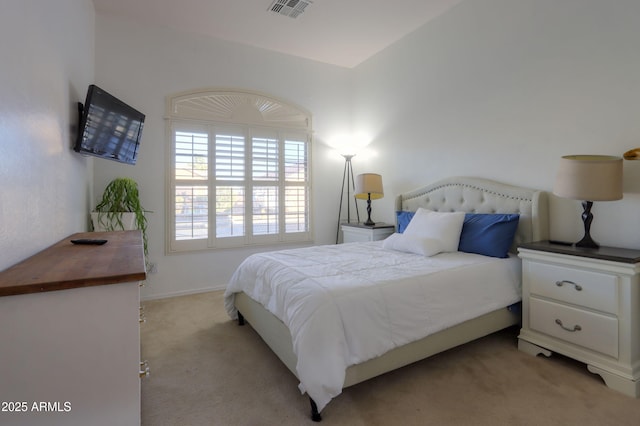 bedroom featuring light colored carpet