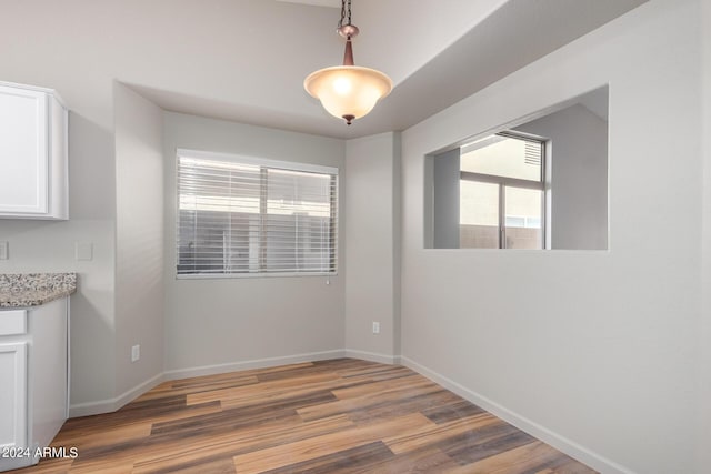 unfurnished dining area with hardwood / wood-style floors