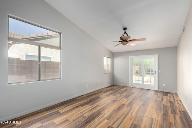 spare room featuring lofted ceiling, dark wood-type flooring, and ceiling fan