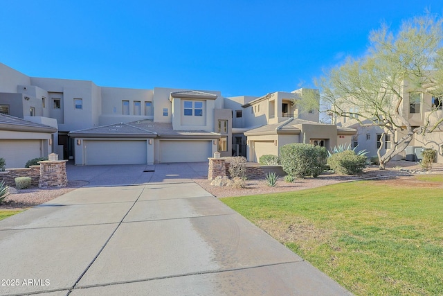 view of front of house featuring a garage and a front lawn