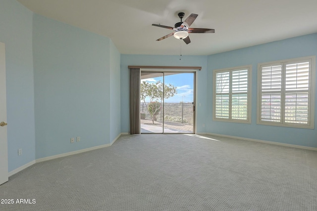 empty room featuring light carpet and ceiling fan