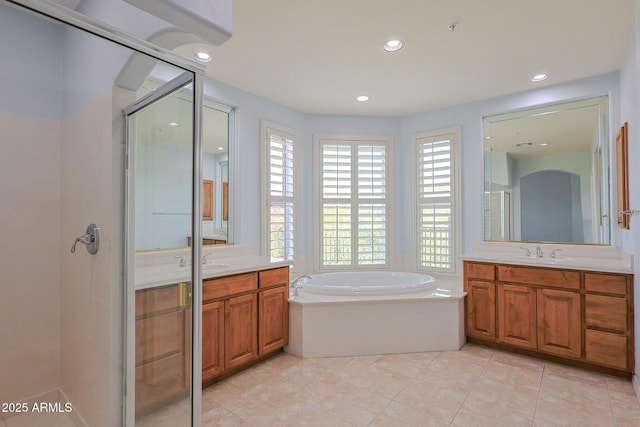 bathroom with vanity, tile patterned floors, and shower with separate bathtub