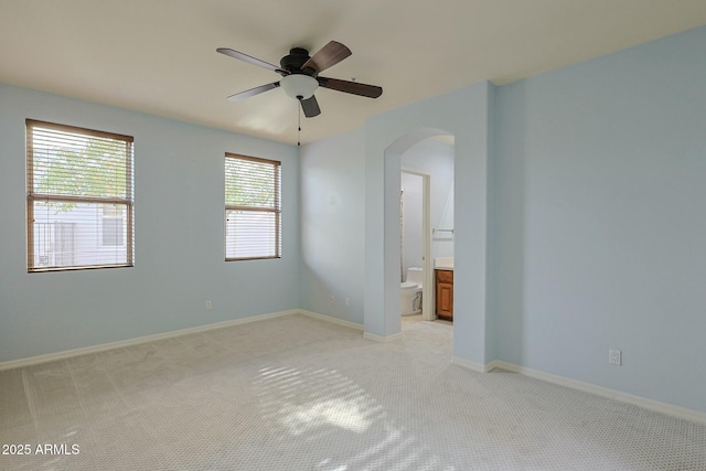 carpeted spare room featuring ceiling fan