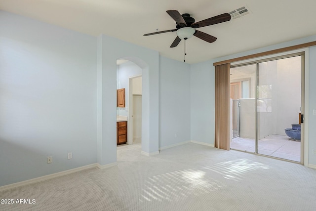 carpeted spare room featuring ceiling fan