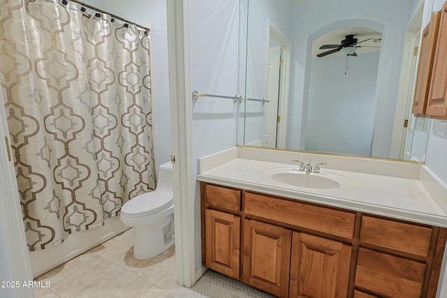 full bathroom featuring shower / bath combination with curtain, tile patterned flooring, vanity, ceiling fan, and toilet