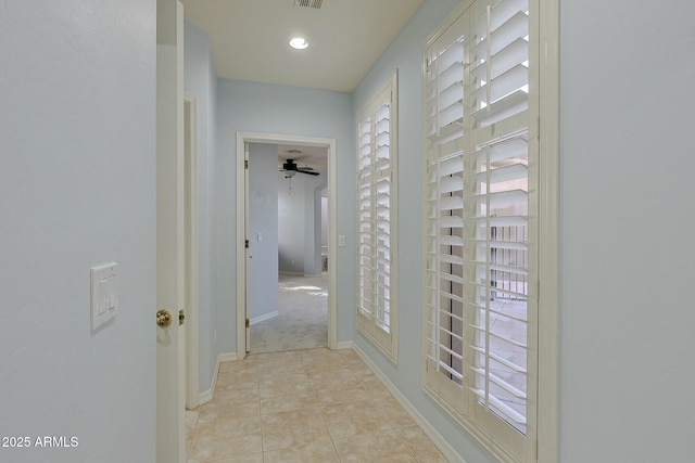 corridor featuring light tile patterned floors