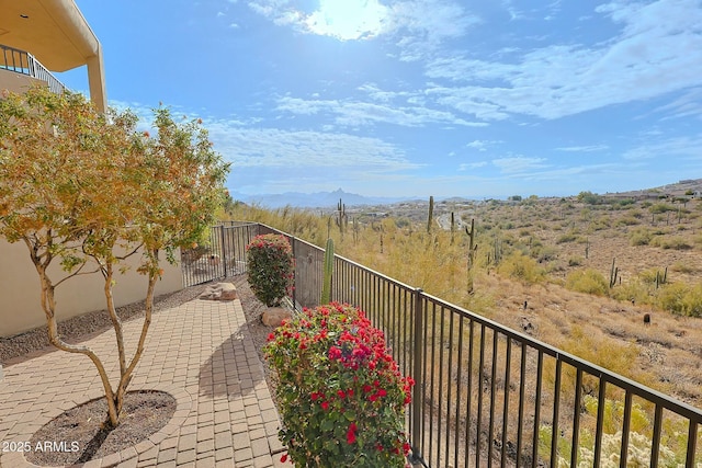 balcony with a mountain view and a patio