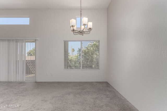 11260 N 92nd St Unit 2102, Scottsdale, AZ 85260 - carpeted spare room featuring a chandelier and a towering ceiling