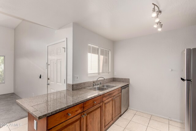 11260 N 92nd St Unit 2102, Scottsdale, AZ 85260 - kitchen featuring appliances with stainless steel finishes, brown cabinets, and light tile patterned floors