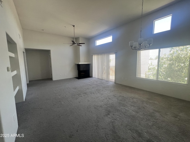 11260 N 92nd St Unit 2102, Scottsdale, AZ 85260 - unfurnished living room featuring healthy amount of natural light, a chandelier, a high ceiling, carpet flooring, and a ceiling fan