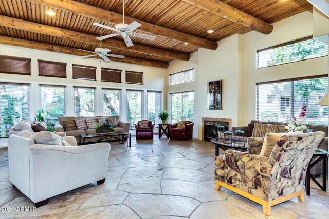 11260 N 92nd St Unit 2102, Scottsdale, AZ 85260 - living area with a wooden ceiling with exposed beams, a towering ceiling, a ceiling fan, a fireplace, and recessed lighting