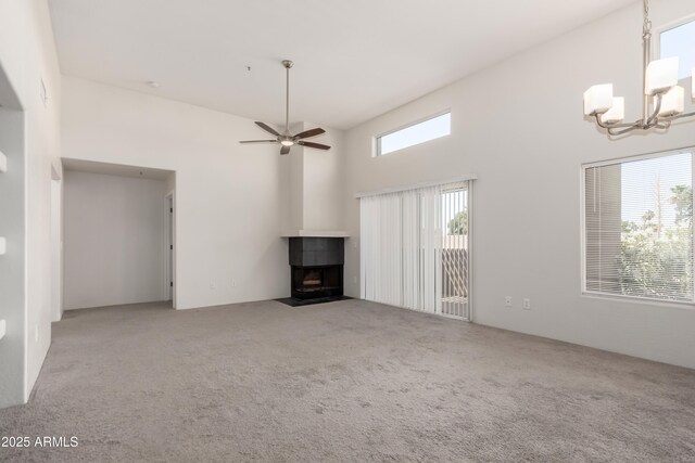 11260 N 92nd St Unit 2102, Scottsdale, AZ 85260 - unfurnished living room featuring carpet floors, a chandelier, a ceiling fan, and a towering ceiling