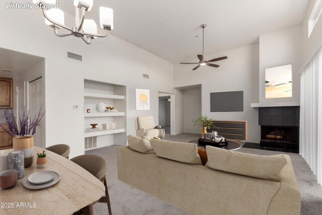 11260 N 92nd St Unit 2102, Scottsdale, AZ 85260 - living area with carpet, built in features, high vaulted ceiling, ceiling fan, and a fireplace