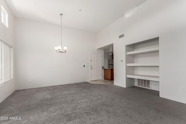 11260 N 92nd St Unit 2102, Scottsdale, AZ 85260 - unfurnished living room featuring a high ceiling, a chandelier, and light colored carpet