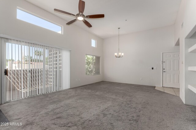 11260 N 92nd St Unit 2102, Scottsdale, AZ 85260 - unfurnished living room with carpet floors, a ceiling fan, a towering ceiling, and a chandelier