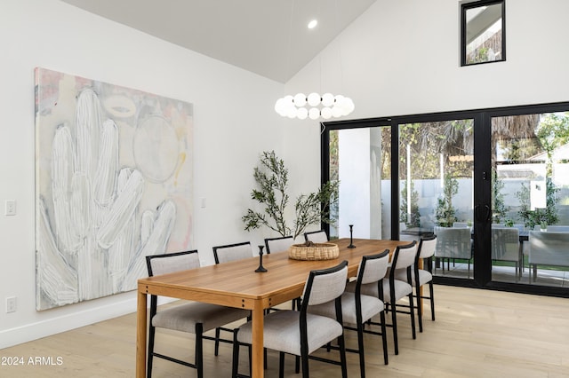 dining room with french doors, light hardwood / wood-style flooring, and high vaulted ceiling