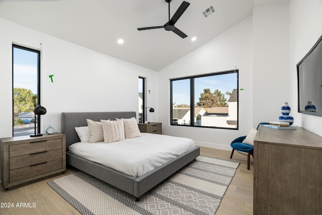 bedroom with light hardwood / wood-style flooring, multiple windows, and ceiling fan