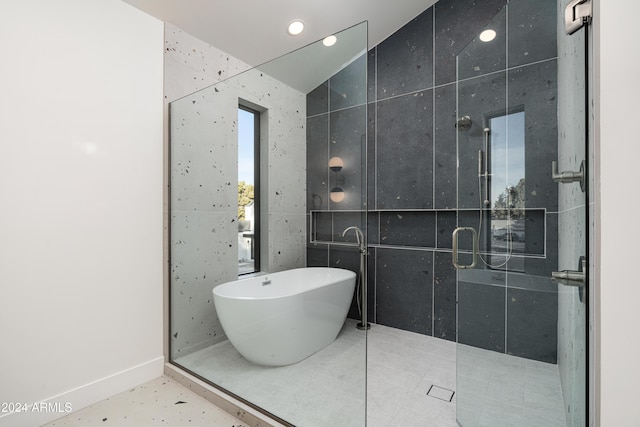 bathroom with plus walk in shower, vaulted ceiling, and tile walls