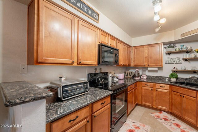 8787 E Mountain View Rd Unit 1110, Scottsdale, AZ 85258 - kitchen featuring black appliances, open shelves, dark stone countertops, light tile patterned floors, and brown cabinetry