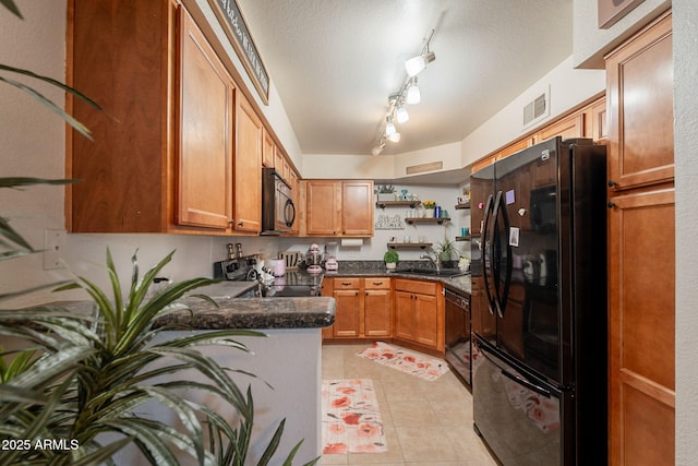 8787 E Mountain View Rd Unit 1110, Scottsdale, AZ 85258 - kitchen featuring black appliances, open shelves, light tile patterned floors, brown cabinetry, and a peninsula