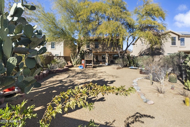 back of property with a playground