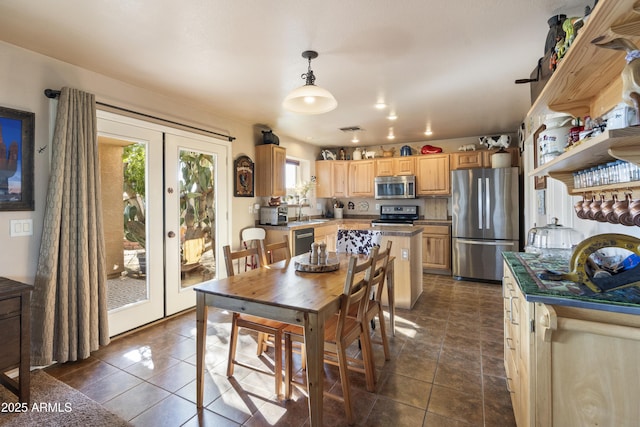 tiled dining space featuring sink and french doors