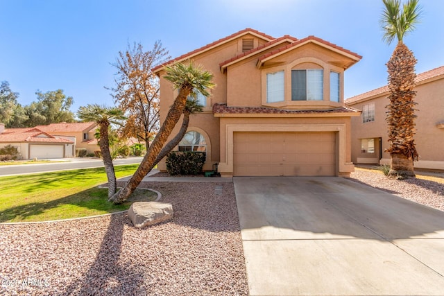 mediterranean / spanish home with a garage, driveway, a tile roof, and stucco siding