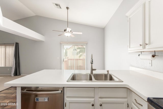 kitchen with lofted ceiling, a sink, visible vents, light countertops, and stainless steel dishwasher