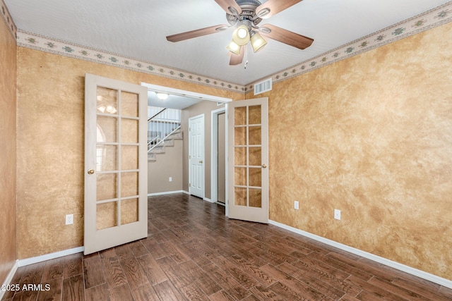 empty room with stairs, visible vents, wood finished floors, and french doors