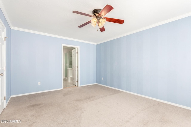 empty room with baseboards, carpet, a ceiling fan, and crown molding