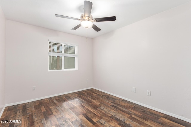 spare room with dark wood finished floors, baseboards, and ceiling fan