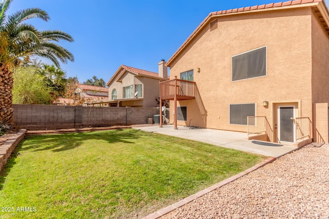 back of property with a lawn, fence, a patio, and stucco siding