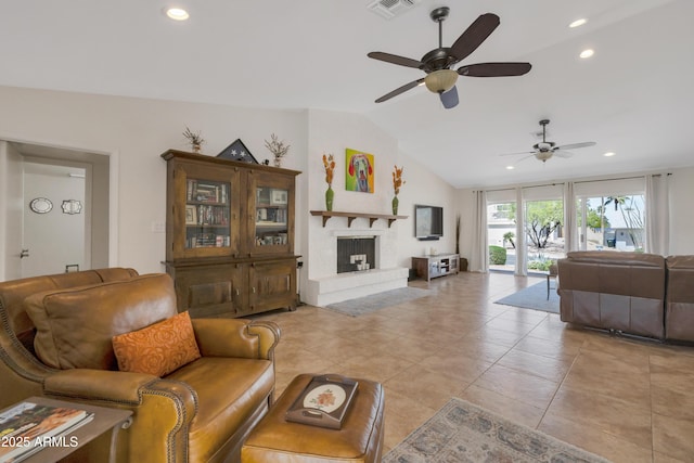 living area with a ceiling fan, a fireplace with raised hearth, visible vents, recessed lighting, and lofted ceiling