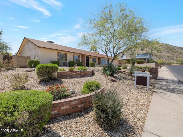 ranch-style home with fence