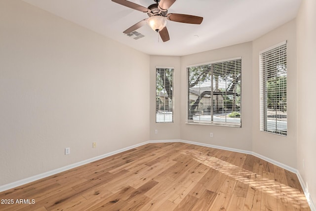 empty room with light hardwood / wood-style floors and ceiling fan