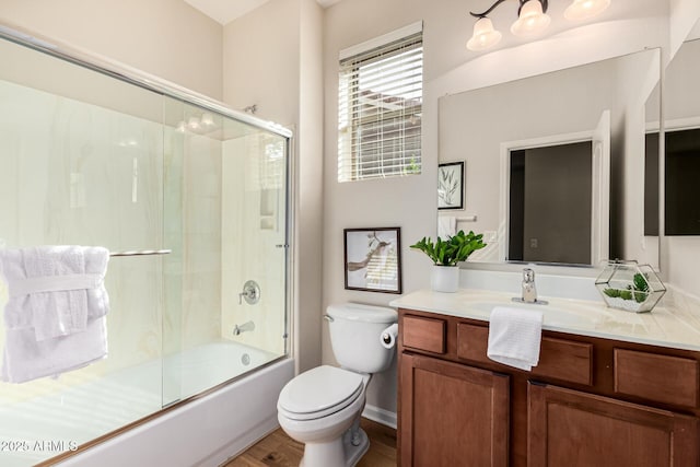 full bathroom featuring wood-type flooring, vanity, toilet, and enclosed tub / shower combo